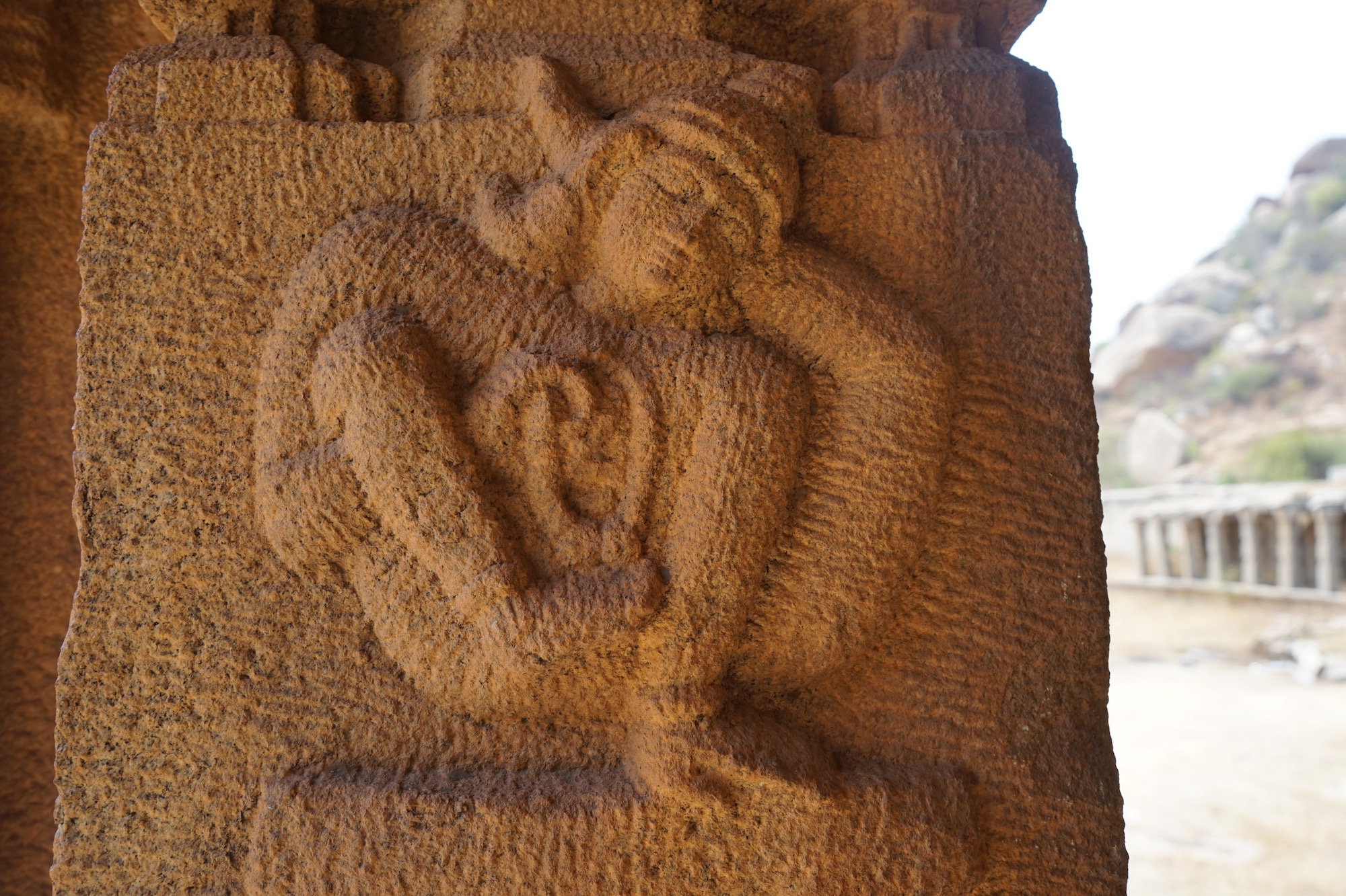 Stone relief of a yogi in āsana